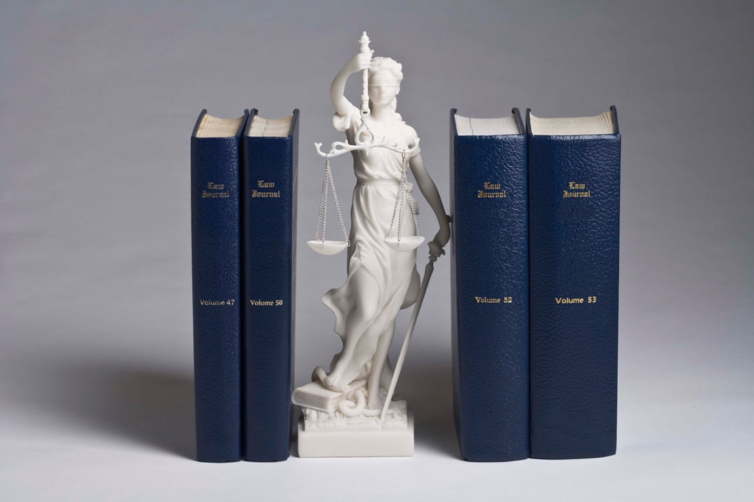 Statue of Lady Justice with law books